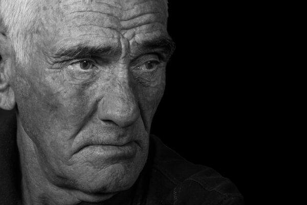 Portrait,Of,An,Elderly,Man,On,Black,Background